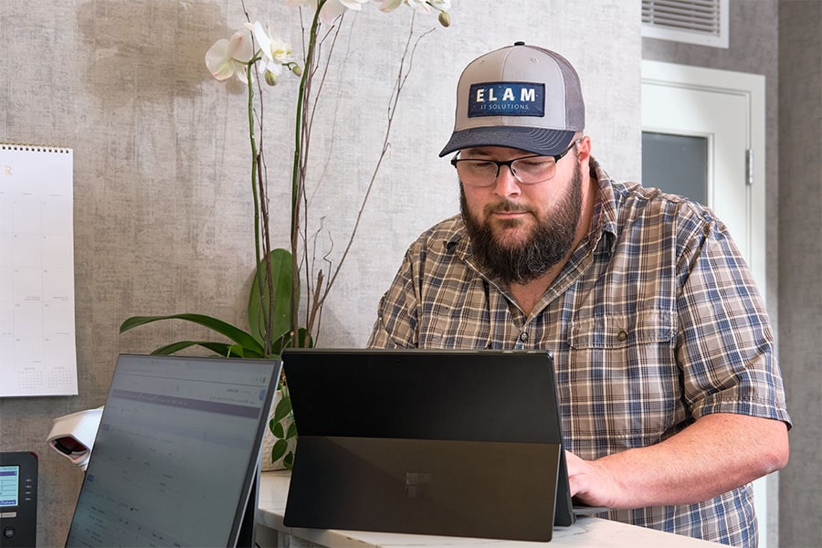 JD Elam, owner working on tablet